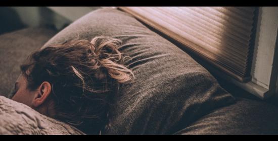 woman sleeping with her head on a pillow