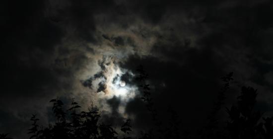 A photograph of the moon in a cloudy night sky 