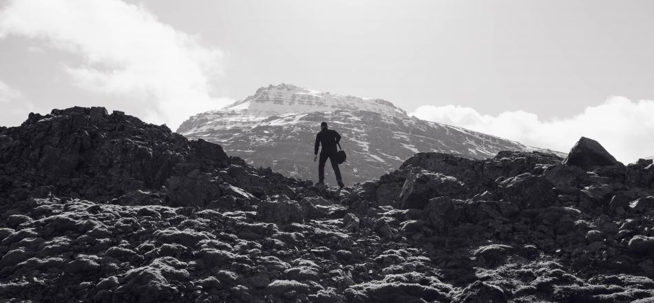 man climbing mountain