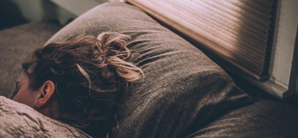 woman sleeping with her head on a pillow