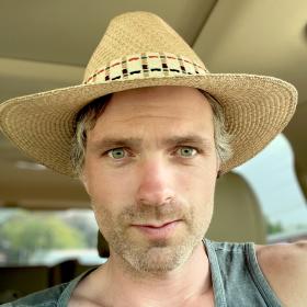 man wearing straw hat sitting in car